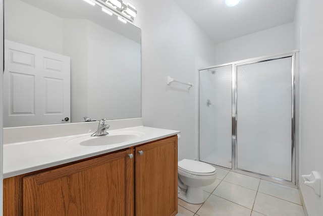 bathroom with vanity, tile patterned floors, a shower with door, and toilet