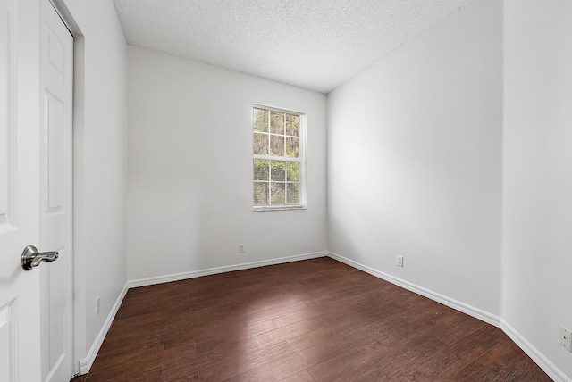 unfurnished room with wood-type flooring and a textured ceiling