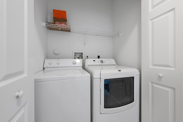 washroom featuring washer and clothes dryer