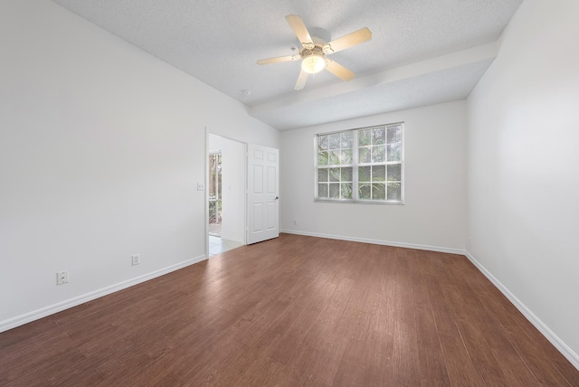 spare room featuring hardwood / wood-style flooring, a textured ceiling, vaulted ceiling, and ceiling fan