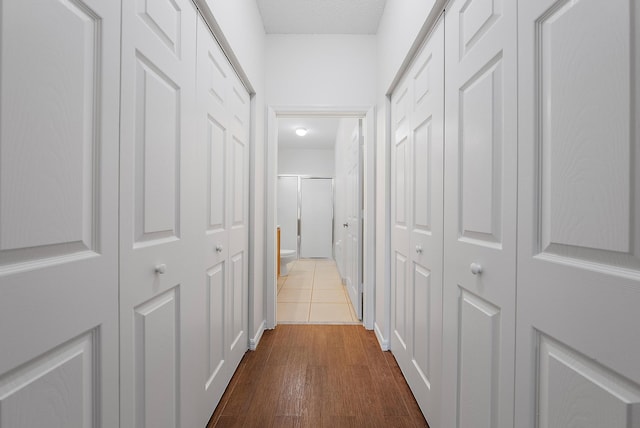 hallway with hardwood / wood-style floors