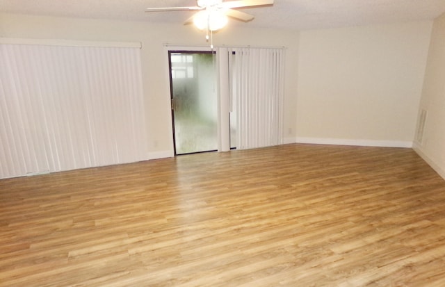 spare room with light wood-type flooring and ceiling fan