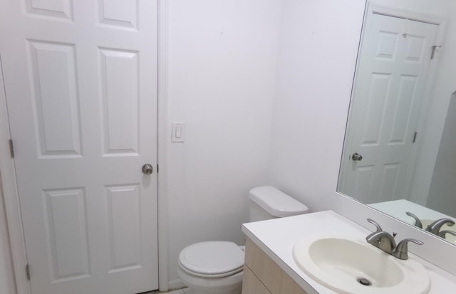 bathroom featuring toilet and vanity