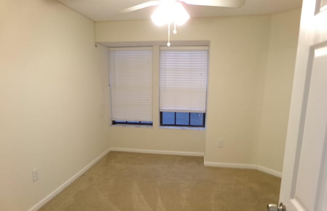 unfurnished room featuring light carpet and ceiling fan