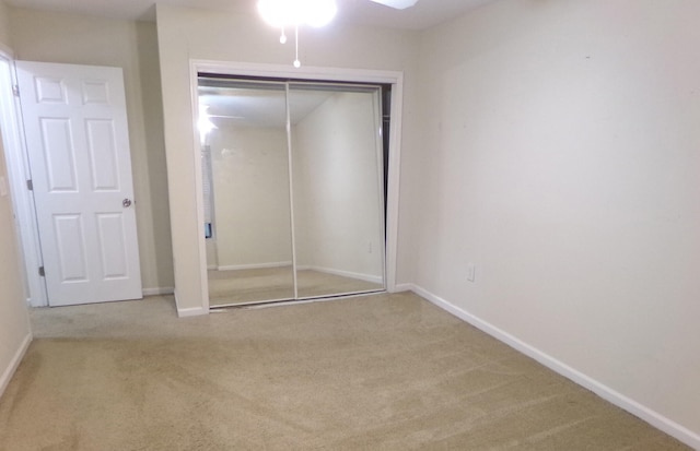 unfurnished bedroom with carpet and a closet