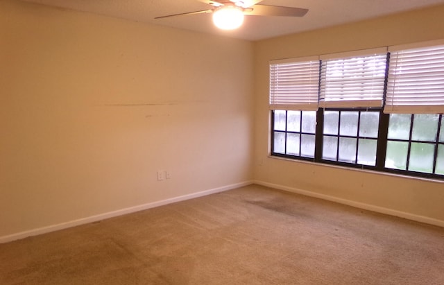 empty room featuring carpet floors and ceiling fan