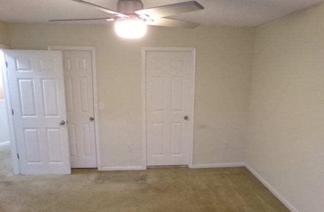 unfurnished bedroom with carpet floors and ceiling fan