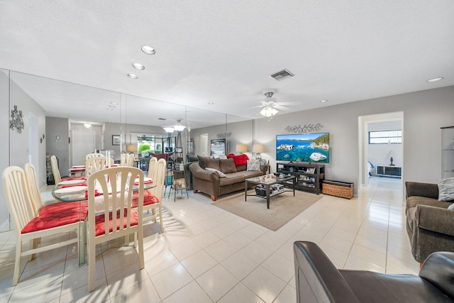 living room featuring ceiling fan and light tile patterned floors