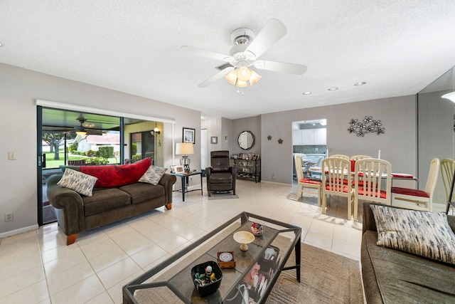 tiled living room featuring a textured ceiling and ceiling fan