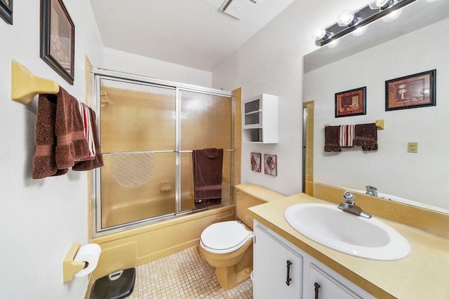 full bathroom featuring toilet, enclosed tub / shower combo, vanity, and tile patterned floors