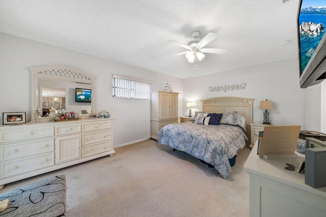 carpeted bedroom featuring a textured ceiling and ceiling fan