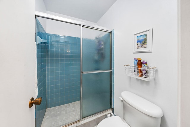 bathroom with toilet and a shower with shower door