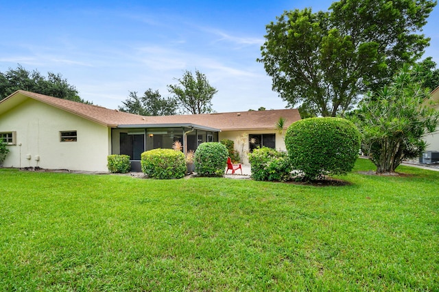 ranch-style house with a sunroom and a front lawn