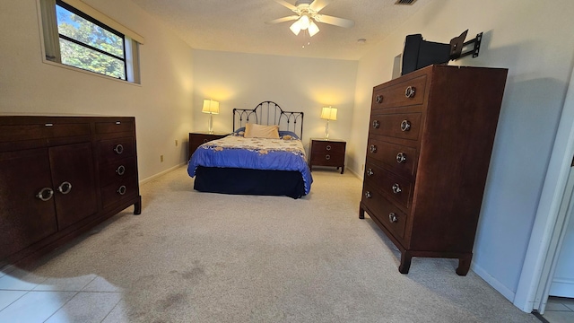 carpeted bedroom with ceiling fan and a textured ceiling