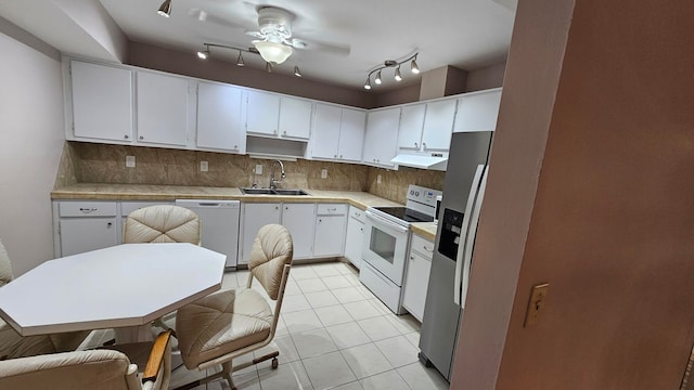 kitchen featuring sink, white cabinets, exhaust hood, and white appliances