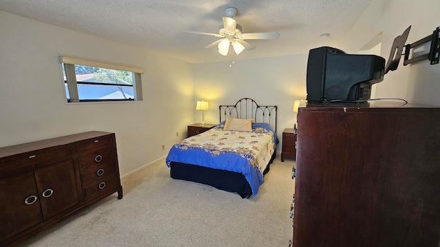 carpeted bedroom featuring a textured ceiling and ceiling fan