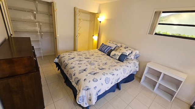 bedroom with a closet and light tile patterned floors