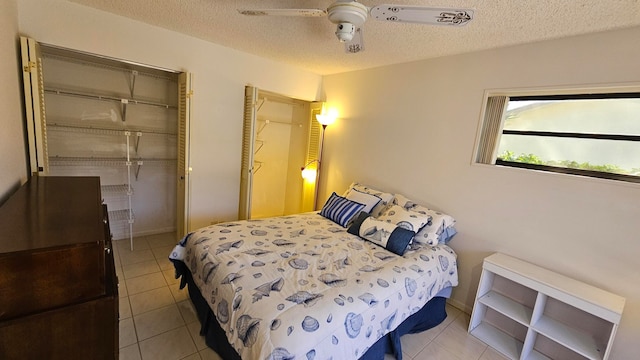 tiled bedroom featuring a closet, ceiling fan, and a textured ceiling