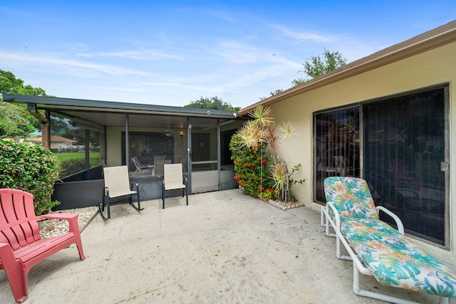 view of patio featuring a sunroom