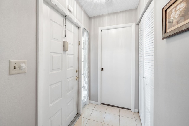 interior space with light tile patterned flooring, a textured ceiling, and plenty of natural light