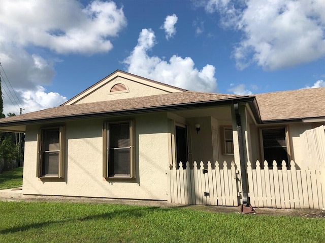 rear view of house with a lawn