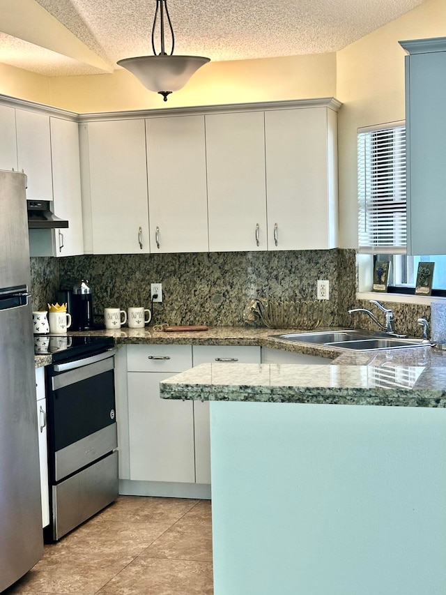 kitchen featuring exhaust hood, white cabinetry, sink, pendant lighting, and stainless steel appliances