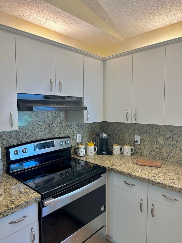 kitchen with light stone counters, electric stove, backsplash, and white cabinets