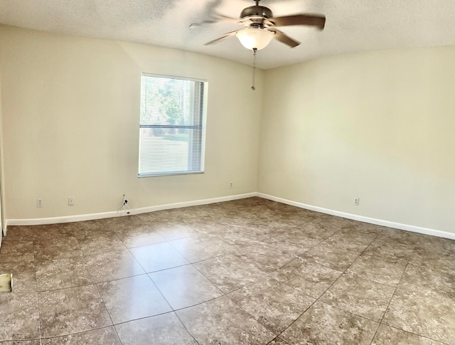 empty room featuring ceiling fan and a textured ceiling