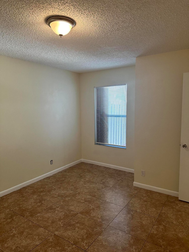 empty room with a textured ceiling