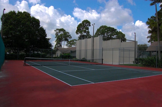 view of tennis court with basketball hoop