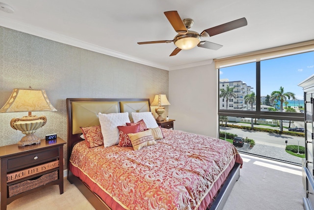 bedroom with ceiling fan, ornamental molding, and light colored carpet