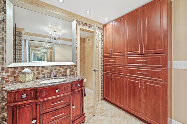 bathroom featuring backsplash, tile patterned floors, a notable chandelier, and vanity