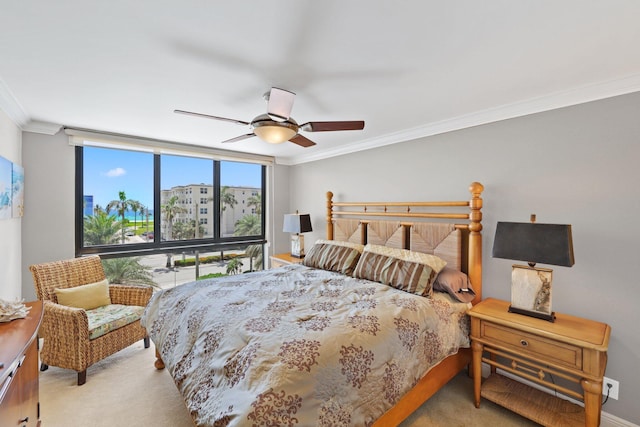 carpeted bedroom featuring crown molding, ceiling fan, and floor to ceiling windows