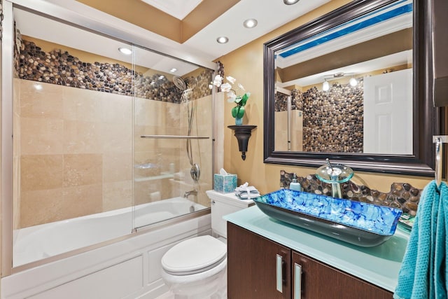 full bathroom featuring vanity, shower / bath combination with glass door, and toilet