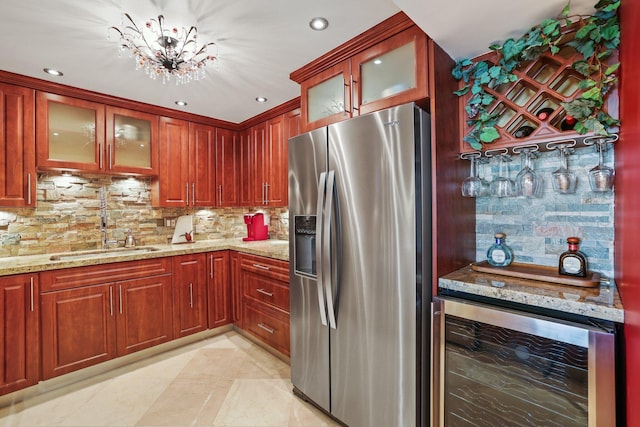 kitchen with stainless steel fridge with ice dispenser, light tile patterned floors, backsplash, beverage cooler, and light stone counters