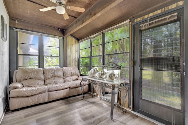 sunroom / solarium with beamed ceiling and ceiling fan