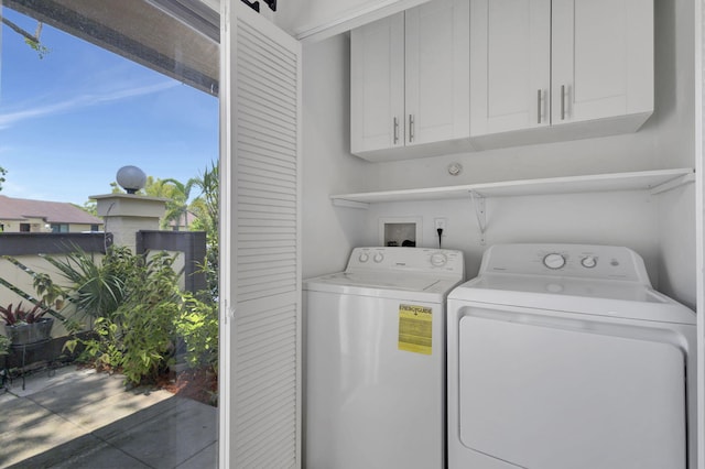 laundry area featuring cabinets and washer and clothes dryer