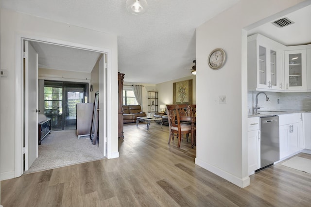 hall with sink and light wood-type flooring