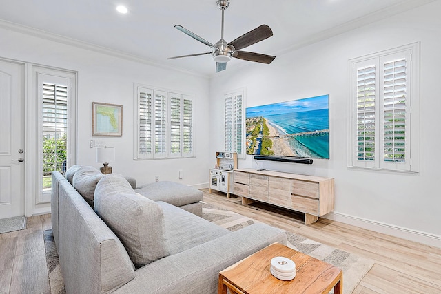 living room featuring hardwood / wood-style floors, ornamental molding, and a wealth of natural light