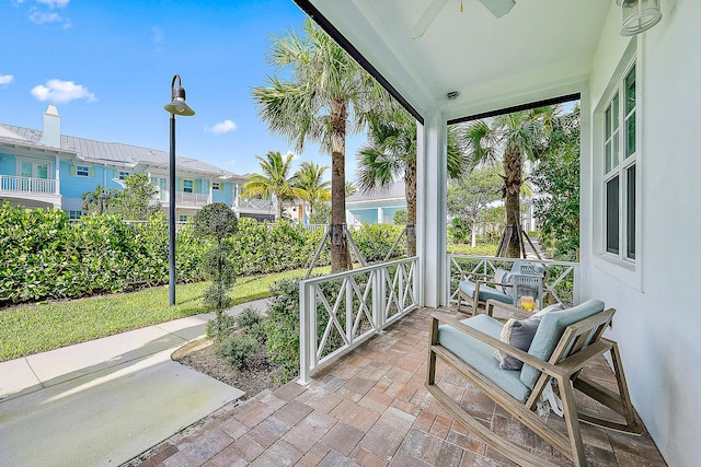 view of patio with ceiling fan and a porch