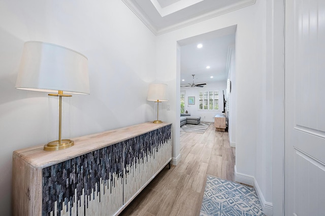 hall featuring wood-type flooring and ornamental molding