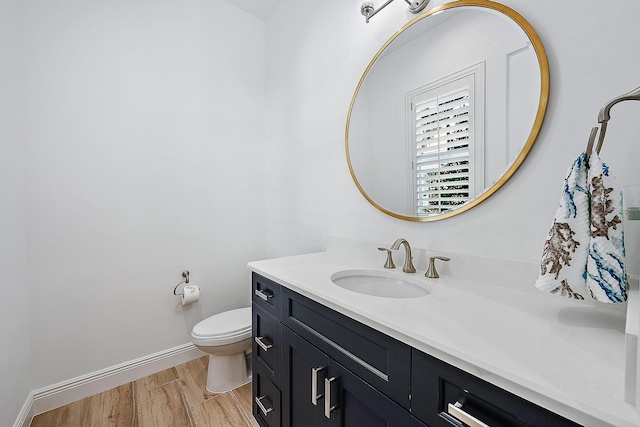 bathroom featuring hardwood / wood-style floors, vanity, and toilet