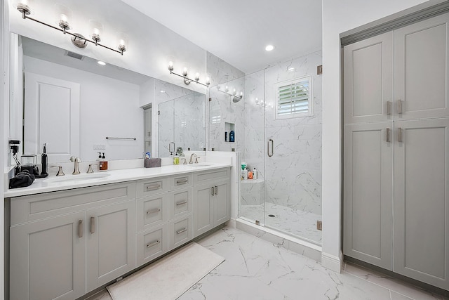 bathroom with vanity and a shower with shower door