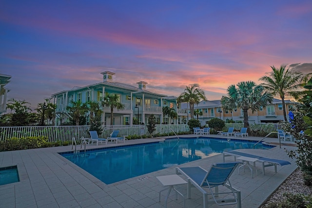 pool at dusk with a patio