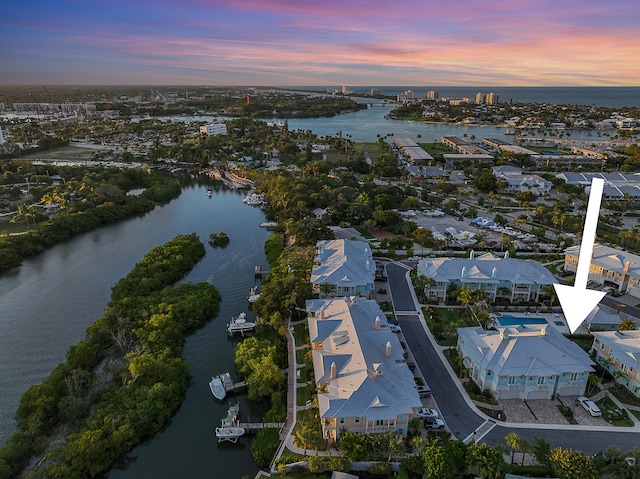 aerial view at dusk with a water view