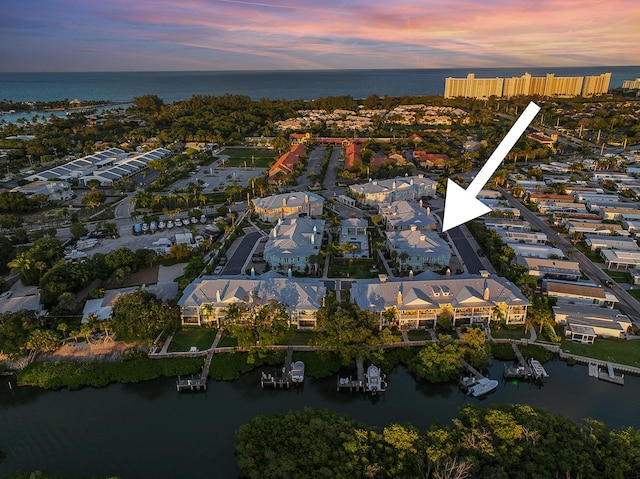 aerial view at dusk with a water view