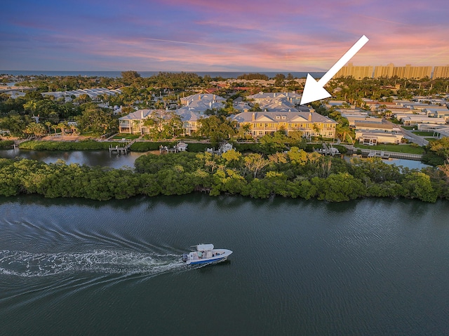 aerial view at dusk with a water view