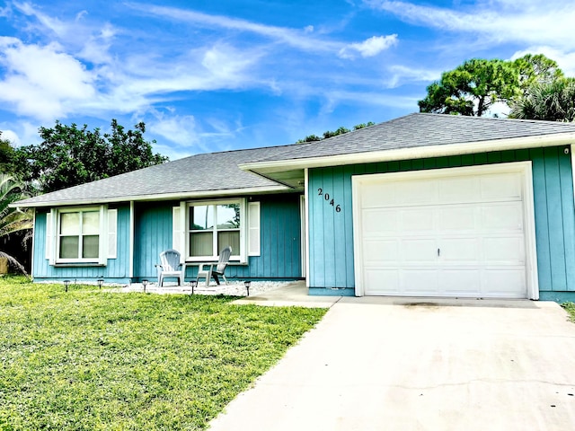 ranch-style home featuring a front yard and a garage