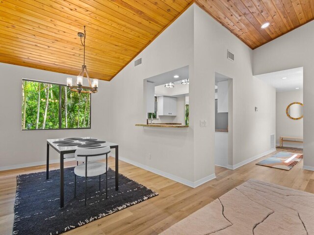 dining area with high vaulted ceiling, light wood-type flooring, and wooden ceiling