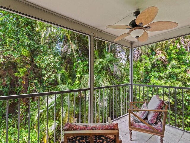 unfurnished sunroom with ceiling fan